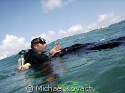 Rescue student contemplating rescue breaths off the beach... by Michael Kovach 